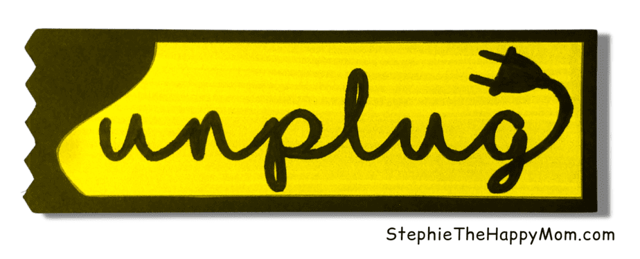 The word unplug is written on an homemade bookmark.